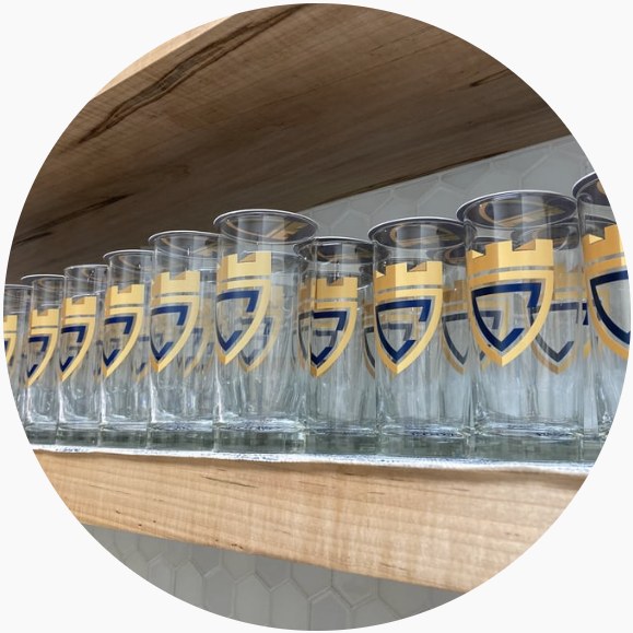 Row of Citadel-crest glasses on a shelf