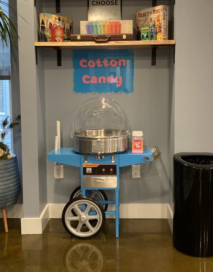 Cotton candy cart nook with board games on the shelves above