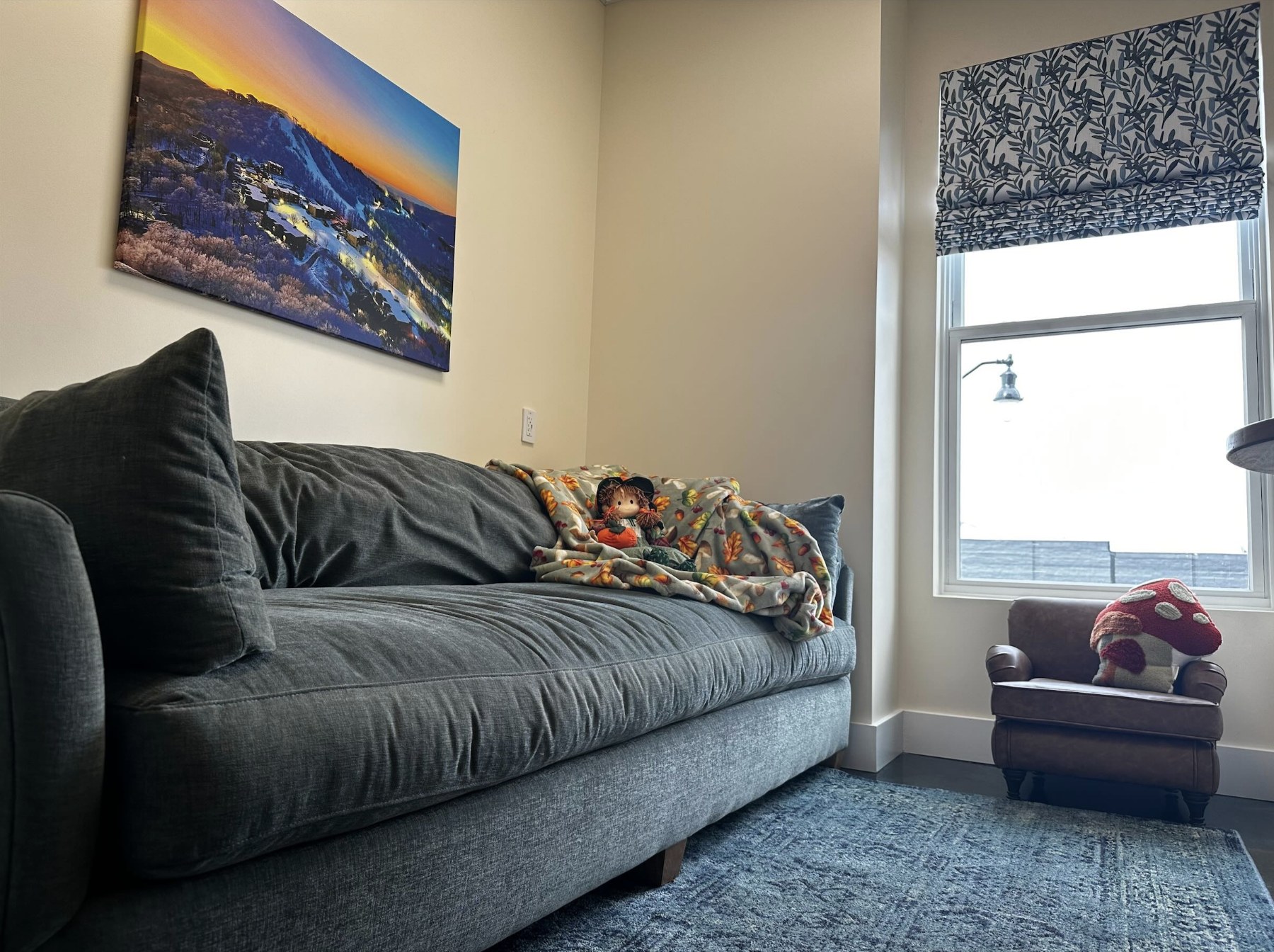 The Kid Cave room with a comfy couch, TV, and kid-sized chair